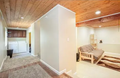 a living room with a couch and wooden ceiling at Bernina Dr. Retreat in Pine Mountain Club