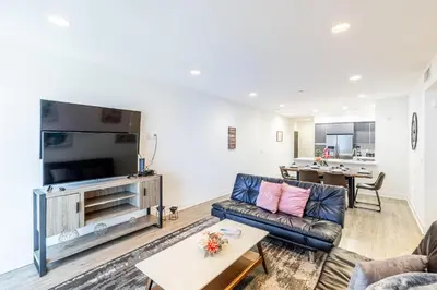 a living room with a couch and a flat screen tv at Hollywood Furnished Apartments in Los Angeles