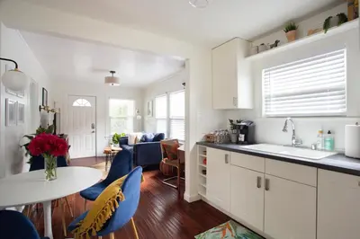 a kitchen and living room with a table and chairs at Stylish 2bed 2bath Culver Cottage with bicycles in Los Angeles