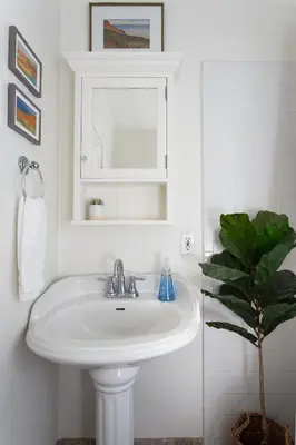 a white sink in a bathroom with a plant at Stylish 2bed 2bath Culver Cottage with bicycles in Los Angeles