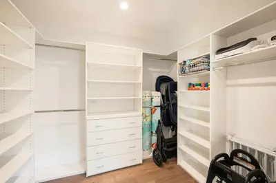 a walk in closet with white drawers and shelves at Beverly Hills Canyon Villa by Stay Awhile Villas in Los Angeles