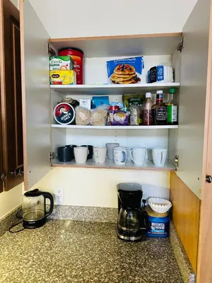a kitchen pantry with food items on shelves at Spacious,2Queen beds, free parking, pool&gym and central location in Marina del Rey