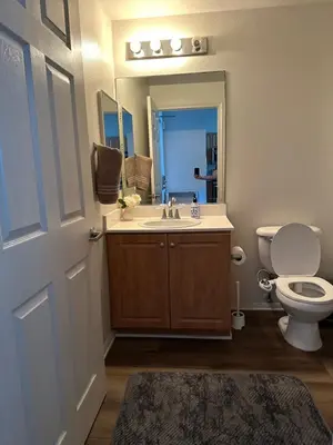 a bathroom with a sink and a toilet and a mirror at Spacious,2Queen beds, free parking, pool&gym and central location in Marina del Rey