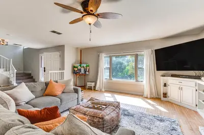 a living room with a couch and a flat screen tv at Beautiful Kernville Home with Game Room and Mtn Views! in Kernville
