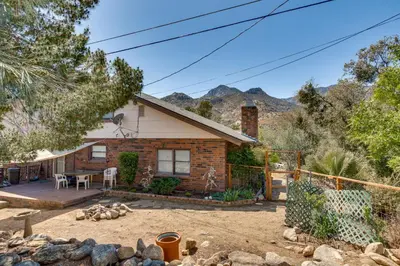 a brick house with a patio and a yard at Beautiful Kernville Home with Game Room and Mtn Views! in Kernville