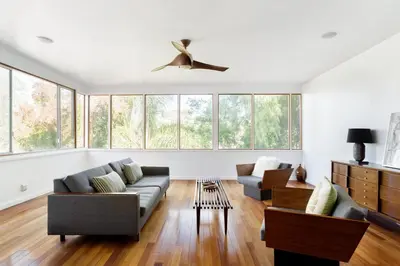 a living room with a couch and chairs and windows at Silver Lake Mid-century Nestled in the Treetops in Los Angeles