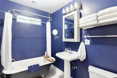 a blue bathroom with a sink and a tub and a toilet at Silver Lake Mid-century Nestled in the Treetops in Los Angeles