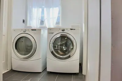 two washing machines sitting next to each other in a room at Modern La Cresta in Bakersfield