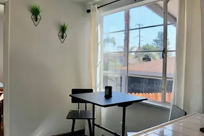 a black table in a room with a window at Modern La Cresta in Bakersfield
