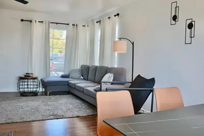 a living room with a couch and a table at Modern La Cresta in Bakersfield