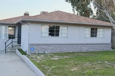 a white house with a window and a door at Modern La Cresta in Bakersfield