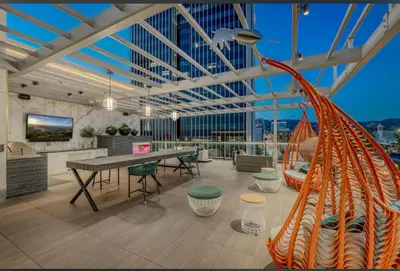 a large room with a table and chairs in a building at Hollywood Penthouse with Balcony & Pool View in Los Angeles