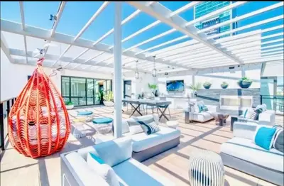 a living room with white furniture and a glass ceiling at Hollywood Penthouse with Balcony & Pool View in Los Angeles