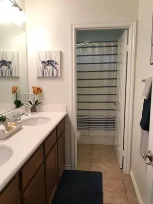 a bathroom with two sinks and a shower at Bella's sweet house 5608 in Eastvale
