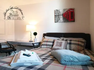 a bedroom with a bed with pillows and a red phone booth at Bella's sweet house 5608 in Eastvale