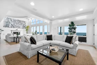 a living room with a couch and a table at Coastal Serenity in Malibu