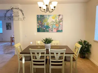 a dining room with a table with chairs and a painting at Bella's sweet house 5640 in Eastvale