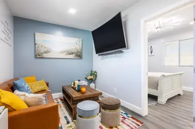 a living room with a couch and a tv at Luxe and Modern South Bay ADU in Carson