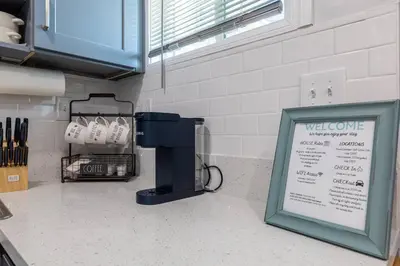 a sign in a kitchen with a welcome sign at Luxe and Modern South Bay ADU in Carson