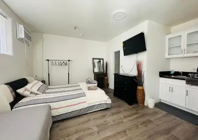 a bedroom with a large bed and a kitchen at Sunset & La brea studio!! Best location ever in Los Angeles