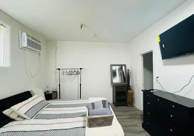 a bedroom with two beds and a tv on the wall at Sunset & La brea studio!! Best location ever in Los Angeles