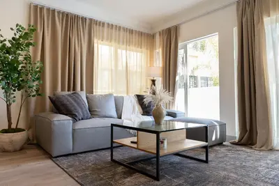 a living room with a couch and a table at Charming 2bd Condo on SunsetStrip in Los Angeles