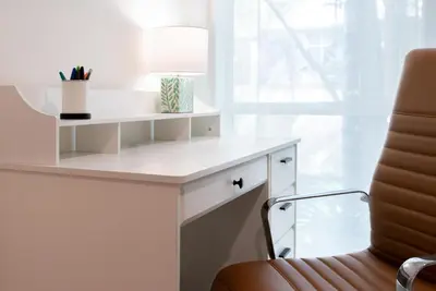 a desk with a lamp and a chair at Charming 2bd Condo on SunsetStrip in Los Angeles