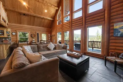 a living room with a couch and a table at Lakeview Lodge - Across the street from the lake and Boulder Bay Park! in Big Bear Lake