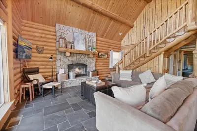 a living room with a couch and a fireplace at Lakeview Lodge - Across the street from the lake and Boulder Bay Park! in Big Bear Lake