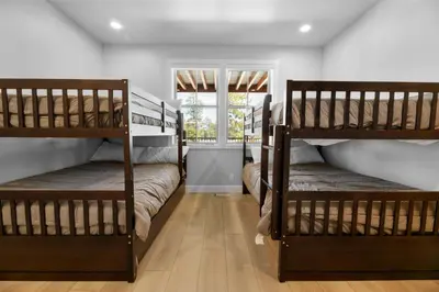 two bunk beds in a room with a window at Pine Meadow - Game Room with pool table, foosball & shuffleboard! in Big Bear Lake