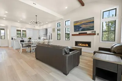 a living room with a couch and a fireplace at Pine Meadow - Game Room with pool table, foosball & shuffleboard! in Big Bear Lake