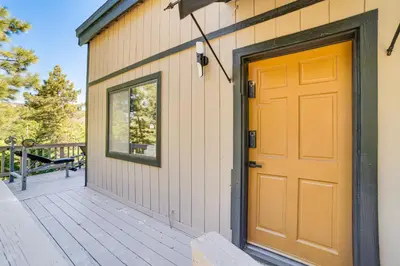a orange door on a building with a deck at Pine Mountain Club Cabin with AandC and EV Charger in Pine Mountain Club