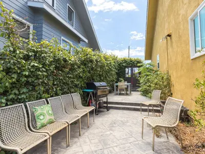 a patio with chairs and a piano next to a building at El Segundo Beach 5B4b Home, POOL Hot Tub, BEACHES, Local Town! in El Segundo