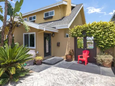 a red chair sitting outside of a house at El Segundo Beach 5B4b Home, POOL Hot Tub, BEACHES, Local Town! in El Segundo