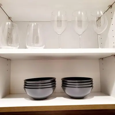 two bowls and wine glasses sitting on shelves at Spacious 22, Wi-fi, Pool, Hot Tub, 24hr Gym in Los Angeles