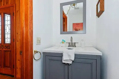 a bathroom with a sink and a mirror at North Shore Chalet Lake View, Spa and Game Rooms in Fawnskin