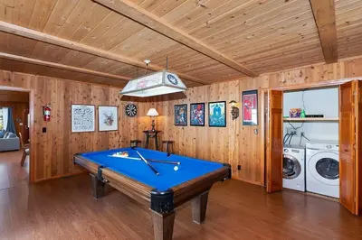 a pool table in a room with wooden walls at North Shore Chalet Lake View, Spa and Game Rooms in Fawnskin