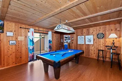 a pool table in a room with wooden walls at North Shore Chalet Lake View, Spa and Game Rooms in Fawnskin
