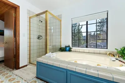 a large bathroom with a tub and a window at North Shore Chalet Lake View, Spa and Game Rooms in Fawnskin