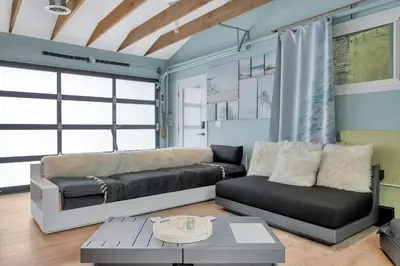 a living room with a couch and a table at NEW BEACH Pool Home, New Industrial OCEAN Vibe, Hot Tub, Pool, Views in El Segundo