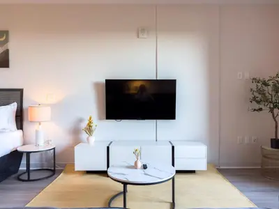 a living room with a white couch and a tv at City View Suite - DTLA by Monthier in Los Angeles