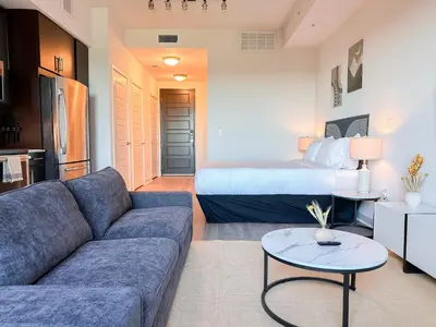 a living room with a couch and a bed at City View Suite - DTLA by Monthier in Los Angeles