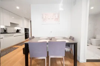 a kitchen and dining room with a table and chairs at Lavish High-Rise 2bed Apt in the Hearth of Downtown LA in Los Angeles