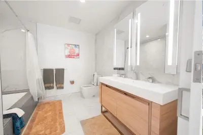 a white bathroom with a sink and a toilet at Lavish High-Rise 2bed Apt in the Hearth of Downtown LA in Los Angeles