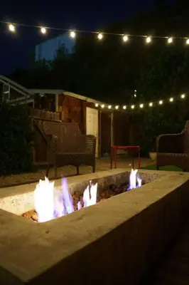 a fire pit in a backyard at night with lights at Cozy 3 Bedroom Hollywood Home- Quick Walk To All Tourist Spots! in Los Angeles