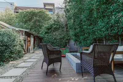 three chairs sitting on a patio with a fountain at Cozy 3 Bedroom Hollywood Home- Quick Walk To All Tourist Spots! in Los Angeles