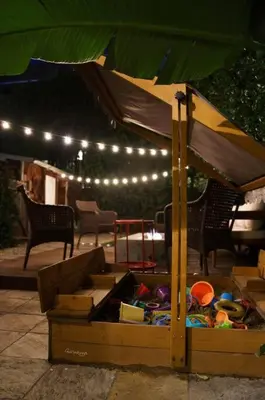 a table with an umbrella on a patio at Cozy 3 Bedroom Hollywood Home- Quick Walk To All Tourist Spots! in Los Angeles
