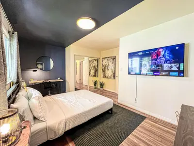 a bedroom with a bed and a tv on the wall at Diamond in Los Angeles- AM3 in Los Angeles