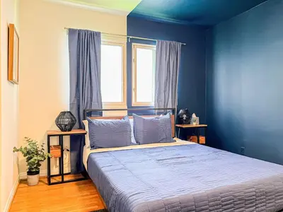 a bedroom with a bed with blue walls and a window at Diamond in Los Angeles- AM3 in Los Angeles