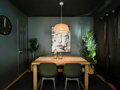 a dining room table with two chairs and a clock at Diamond in Los Angeles- AM3 in Los Angeles